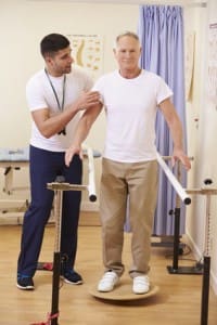 Senior Male Patient Having Physiotherapy In Hospital